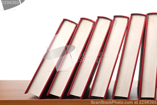 Image of Row of books falling in sequence