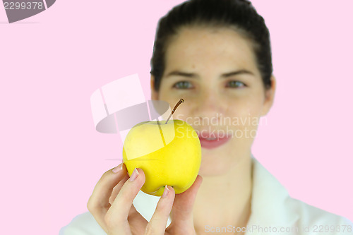 Image of Girl holding a yellow apple