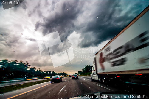 Image of dramtatic sky and clouds with some rain while driving on a highw