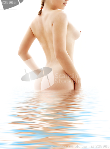Image of naked woman standing in blue water