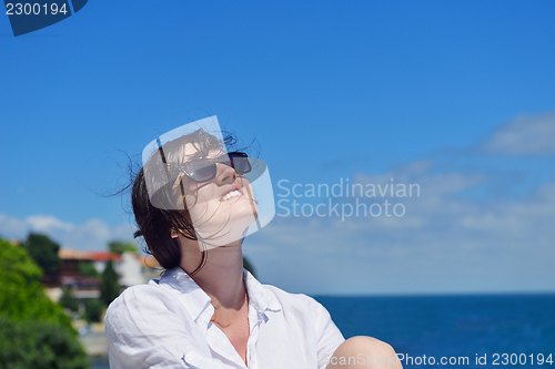 Image of young woman with spreading arms to sky