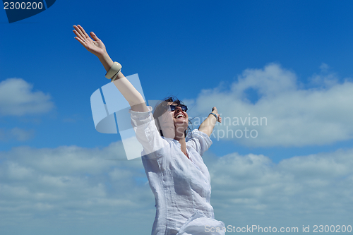 Image of young woman with spreading arms to sky