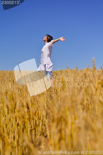 Image of young woman with spreading arms to sky