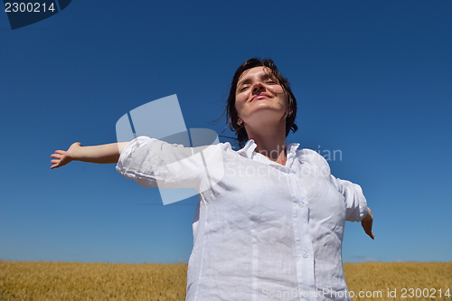 Image of young woman with spreading arms to sky
