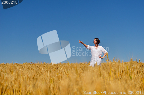 Image of young woman in wheat field at summer
