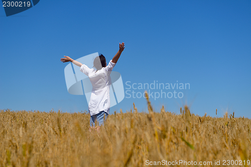 Image of young woman with spreading arms to sky