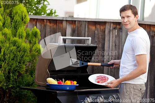 Image of man grilling food