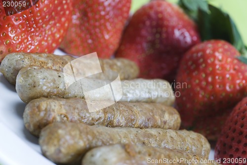 Image of pork sausage links with strawberries