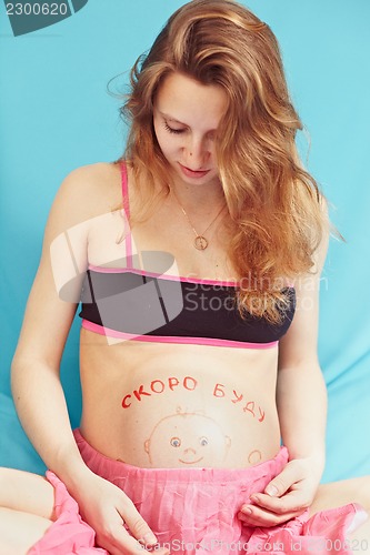 Image of Pregnant girl with a picture