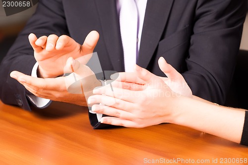 Image of clapping hands in office