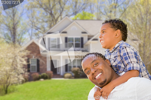 Image of Mixed Race Father and Son In Front of House