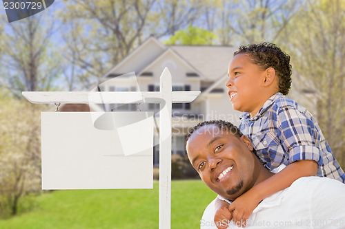 Image of Father and Son In Front of Blank Real Estate Sign and House