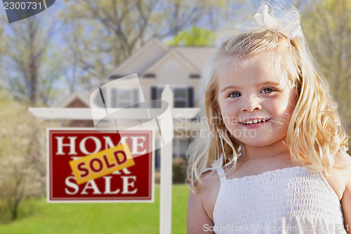 Image of Cute Girl in Yard with Sold For Sale Real Estate Sign and House