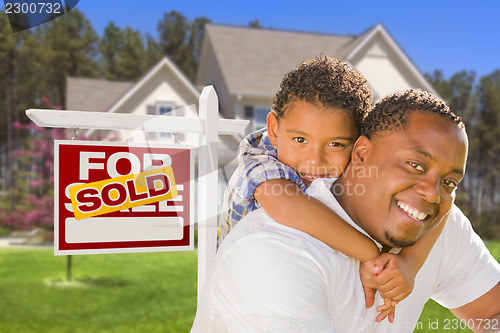 Image of Mixed Race Father and Son In Front of Real Estate Sign and House