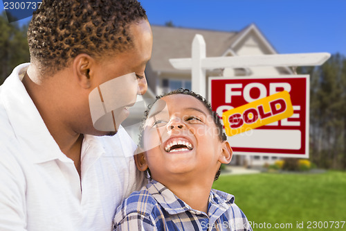 Image of Mixed Race Father and Son In Front of Real Estate Sign and House