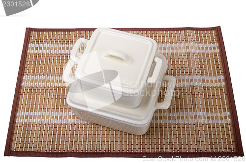 Image of Ceramic pots for stove on bamboo mat