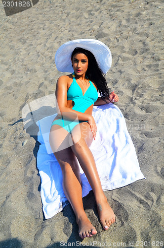Image of Beach girl with hat.