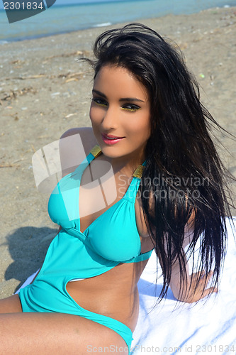Image of Girl sitting on beach.