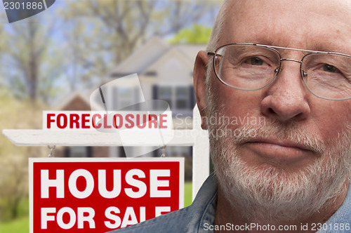 Image of Depressed Senior Man in Front of Foreclosure Sign and House