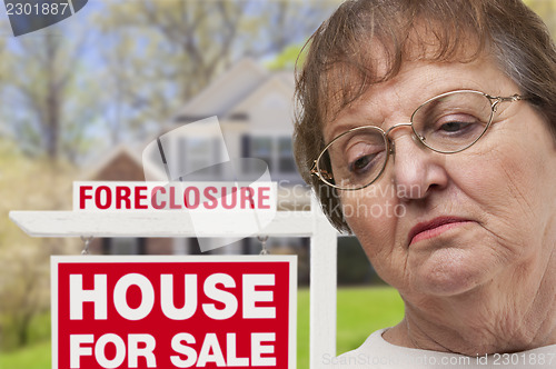 Image of Depressed Senior Woman in Front of Foreclosure Real Estate Sign