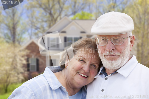 Image of Happy Senior Couple in Front of House