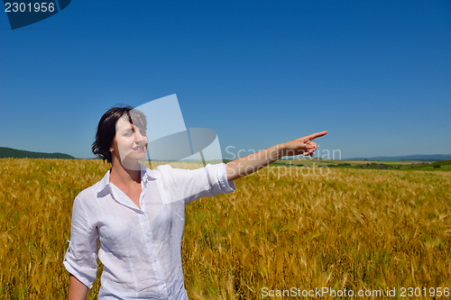 Image of young woman in wheat field at summer