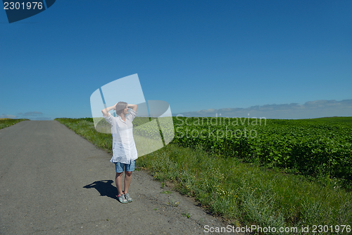 Image of Young happy woman in green field