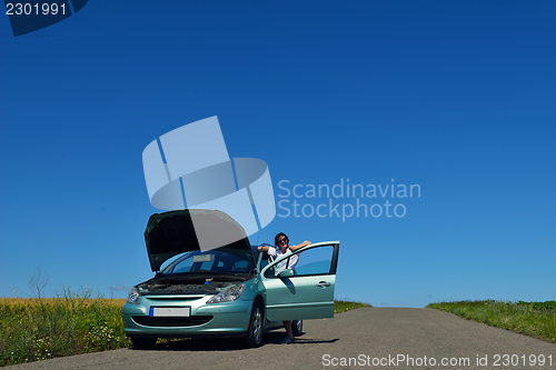 Image of woman with broken car