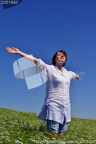 Image of young woman with spreading arms to sky
