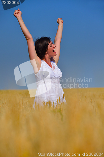 Image of young woman with spreading arms to sky