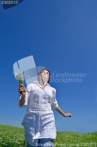 Image of young woman with spreading arms to sky