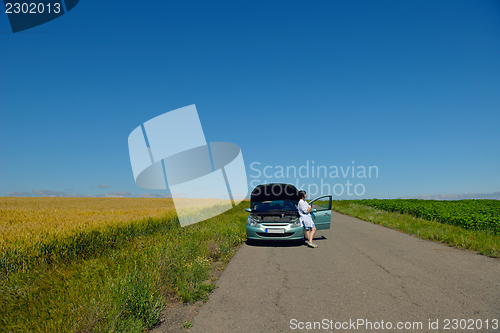 Image of woman with broken car