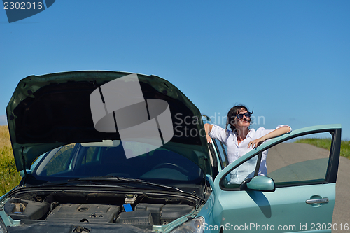 Image of woman with broken car