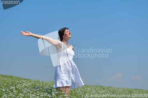 Image of young woman with spreading arms to sky