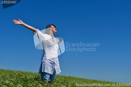Image of young woman with spreading arms to sky