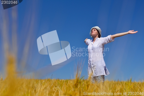 Image of young woman with spreading arms to sky