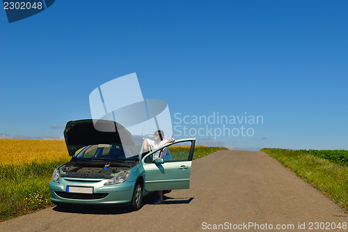 Image of woman with broken car