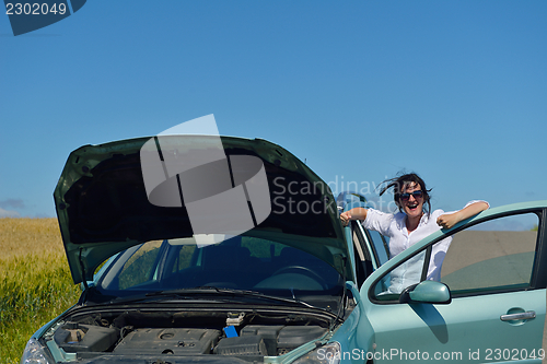 Image of woman with broken car