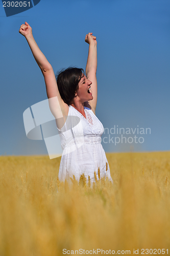 Image of young woman with spreading arms to sky