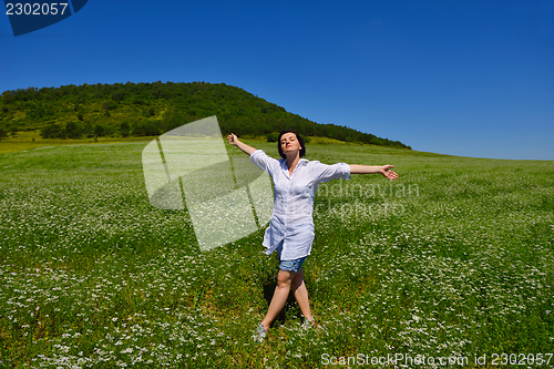 Image of young woman with spreading arms to sky