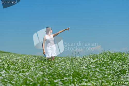 Image of Young happy woman in green field