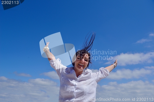 Image of young woman with spreading arms to sky