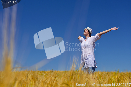 Image of young woman with spreading arms to sky