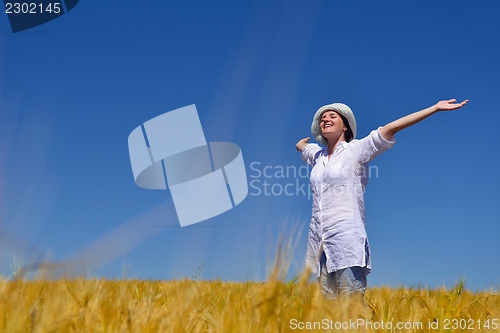 Image of young woman with spreading arms to sky