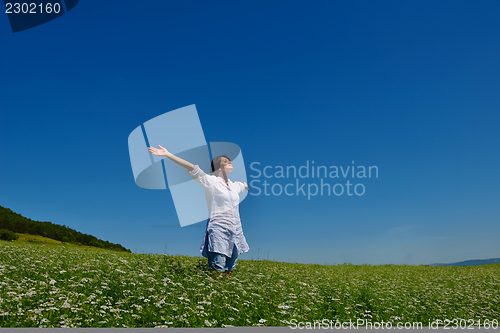Image of young woman with spreading arms to sky