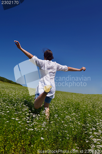 Image of young woman with spreading arms to sky