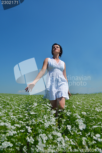 Image of Young happy woman in green field