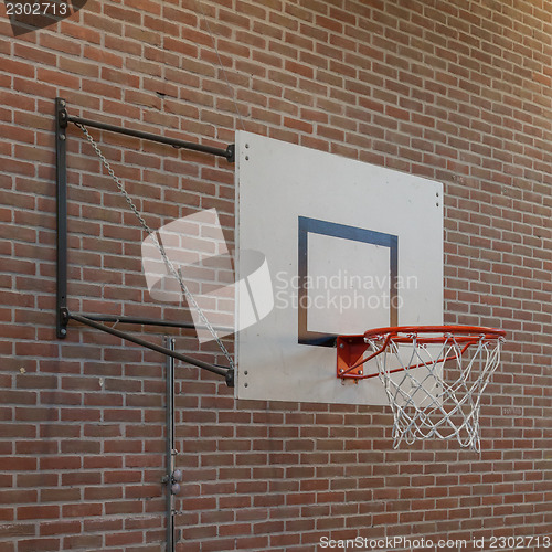 Image of Basketball hoop on an oldbrick wall