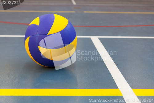 Image of Blue and yellow ball on blue court at break time