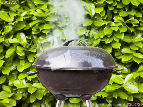 Image of Old black barbecue being used